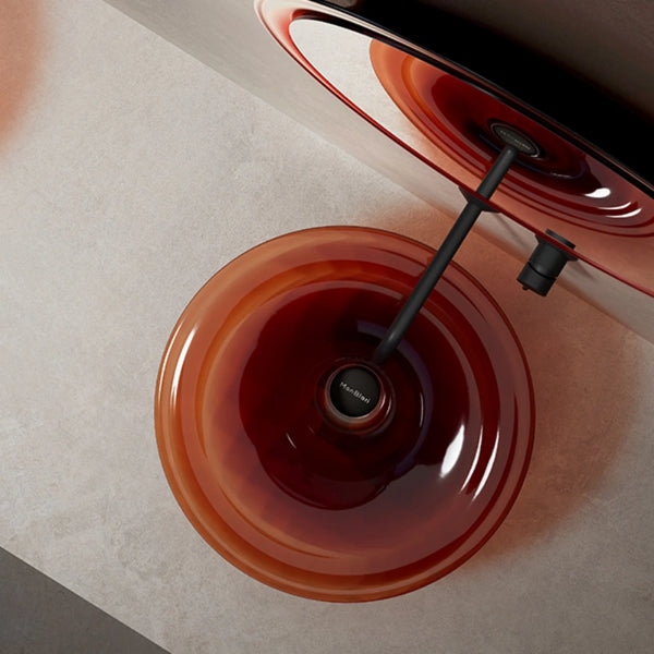 Elegant transparent amber vessel washbasin featuring a glowing sculptural design