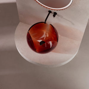 Elegant transparent countertop washbasin with sculptural flower motif and minimalist aesthetic