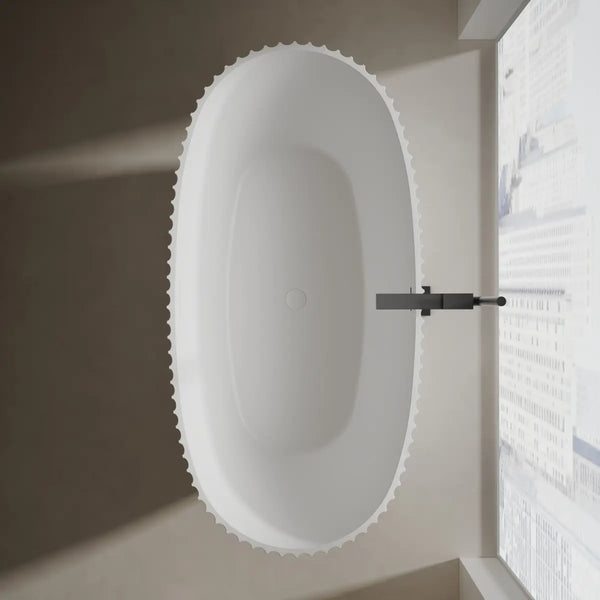 Modern white curved freestanding bathtub with fluted design